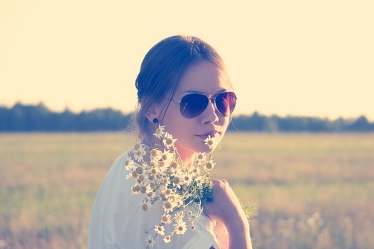 woman with chamomile flowers